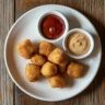 Crispy homemade copycat Chick-fil-A nuggets with dipping sauces.