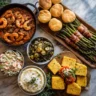 Top-down view of a Southern-style crawfish étouffée meal with 10 vibrant side dishes on a marble background.