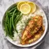 A plate of side dish with tilapia and lemon rice and green beans