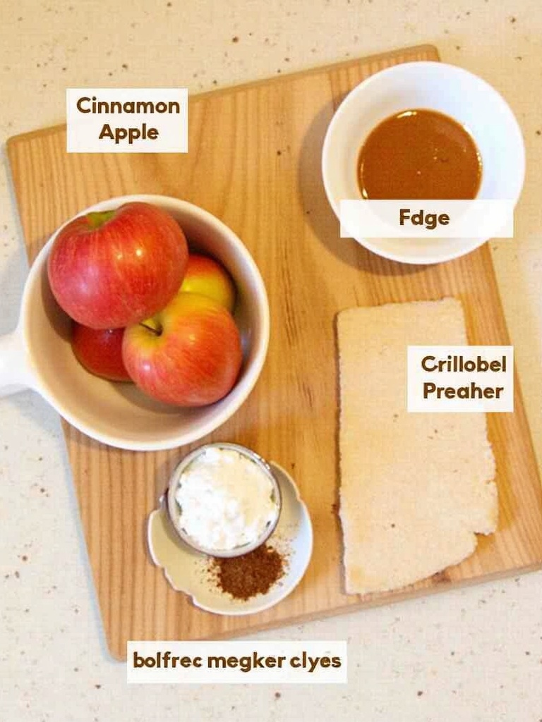 A close-up image of ingredients for baked cinnamon apples, including fresh red apples, a small bowl of brown sugar, cinnamon sticks, a pat of butter on a dish, and a jar of vanilla extract arranged on a wooden surface.